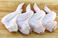 13681558-raw-and-fresh-whole-chicken-wings-on-a-wooden-cutting-board